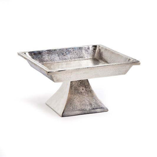 Made of cast aluminum, and finished in brushed nickel, this substantial square pedestal tray is an update on an old classic. Add in some candles, boxwood orbs or books for a polished, well-styled look.