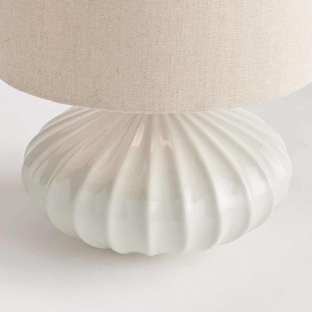 Crafted with intricate detail, the Lillet White Table Lamp boasts a curved ceramic base that sets it apart. Its grand scale and sweeping design make it a striking focal point in any transitional space. Unique, versatile, and elegant, this table lamp is a must-have for any lighting enthusiast.