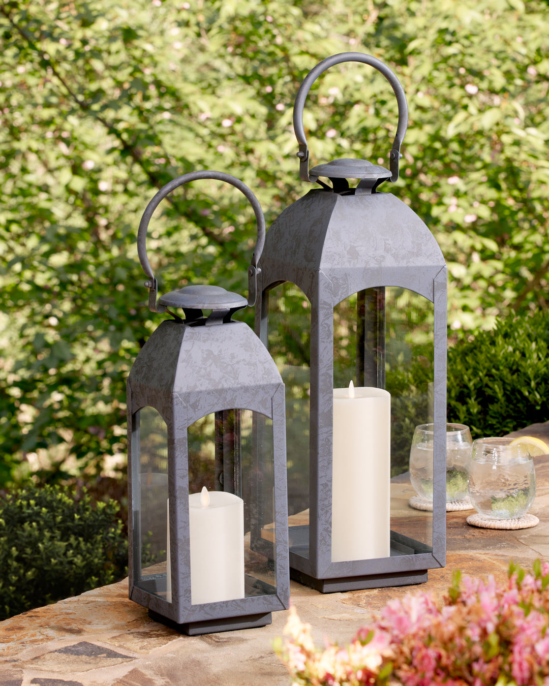 Crafted with a chic faux zinc finish and soft grey tone, this outdoor lantern brings a touch of old European style to your outdoor space. Its vintage-inspired design is true to the authentic qualities of the lantern, perfect for creating a sophisticated ambiance. Enhance your outdoor decor with the Antoinne Outdoor Gray Lantern Small and add a charming European touch.