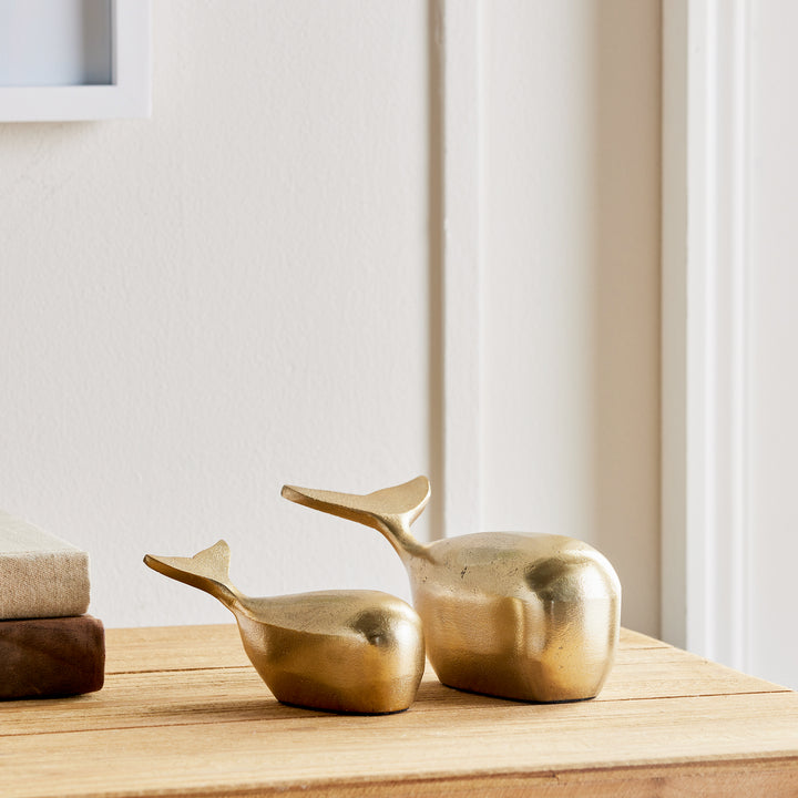 Add a touch of elegance to your coastal-inspired space with this sleek and modern set of Gold Whale Sculptures. Made from durable aluminum, these sculptures are a beautiful and charming accent for any shelf or surface. Whether for an art enthusiast or home decorator, these solid sculptures are sure to impress with their stunning design and construction.