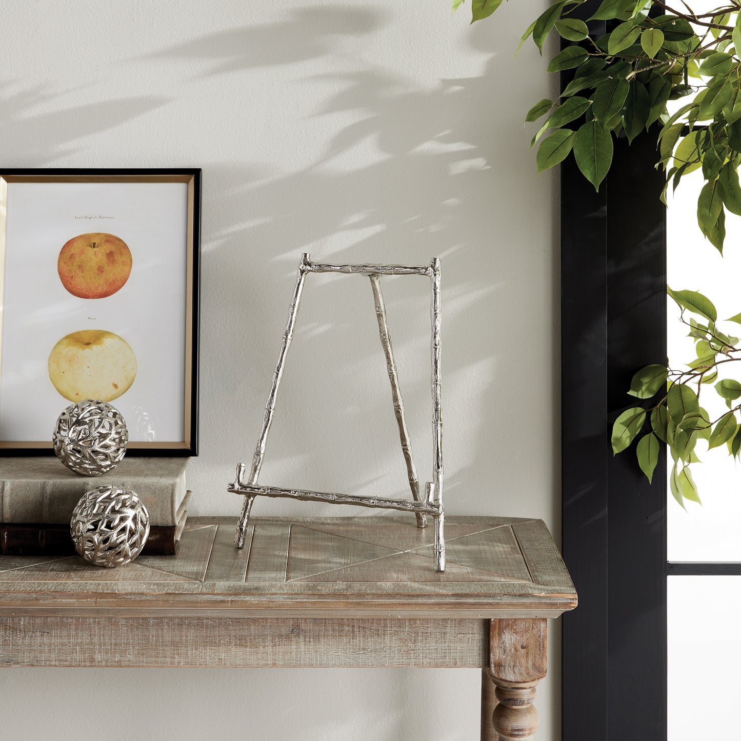 Expertly designed for a variety of uses, this silver easel provides a dependable and sturdy way to display platters, cookbooks, and small artworks. Its strong construction ensures the safety of your items, while the silver accents inspired by bamboo add a timeless touch to your presentation. A versatile and long-lasting choice for showcasing platters, cookbooks, or small artworks.