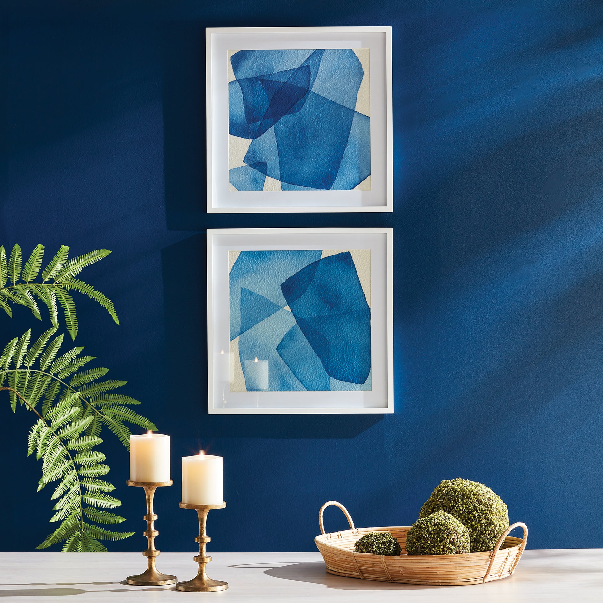 Utilize the stunning layers of abstract blue hues and simple white frame to capture the tranquil essence of the ocean and sky in our Abstract Watercolor Wall Prints Set. This pair of prints perfectly complements the modern coastal atmosphere, adding a touch of sophistication to any space. Choose to elevate your home with our expertly crafted prints.