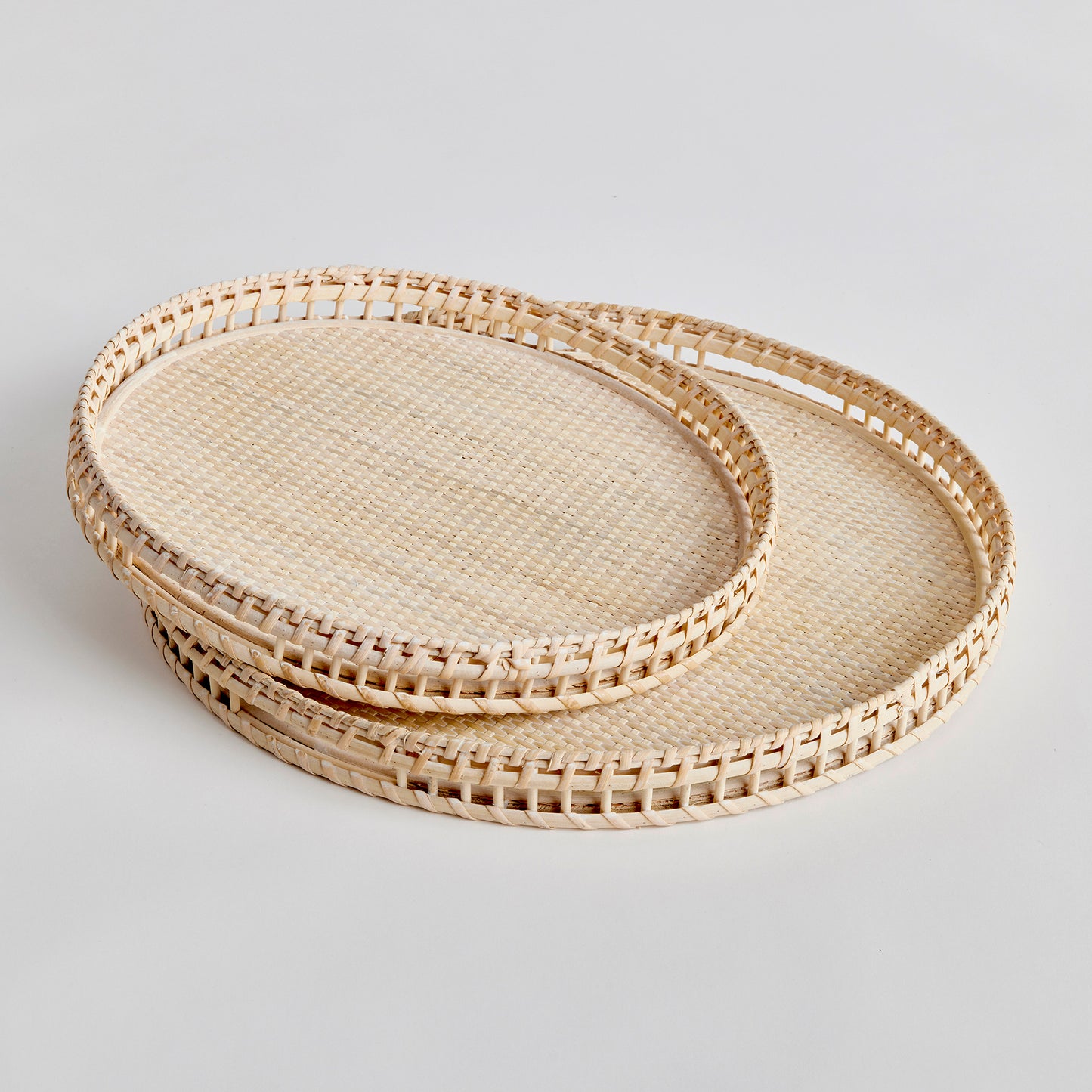 Crafted from woven rattan and coated with a fresh whitewash finish, these coastal-inspired trays add a touch of charm to any space. Use them on your coffee table or ottoman as a stylish base for creating beautiful vignettes. Enhance your home decor with Barri Coastal Decorative Trays Set of 2.