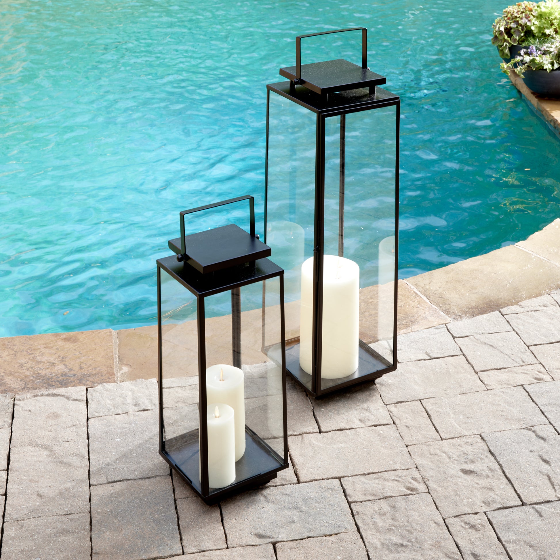 The Alden Outdoor Lantern boasts an elegant, architectural design that is sure to make a statement on your front stoop. With its sleek structure and balanced proportions, it is expertly crafted to provide a touch of sophistication to your outdoor decor. Simply add a glowing candle to create a warm and inviting atmosphere for gatherings.