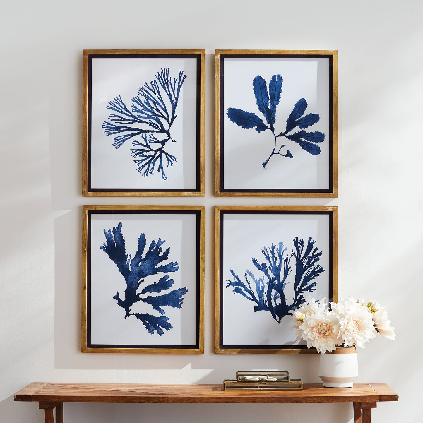 These signature upscale coastal chic prints showcase both elegance and scale. With a soft, watercolor design and whitewashed natural wood frames with indigo trim, these monochromatic seaweed prints add sophistication to any room in your home.