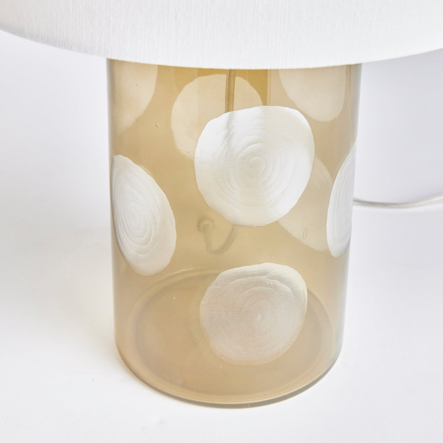 Enhance your home with the Norman Polka Dot Table Lamp, a playful addition that brings a touch of whimsy to any space. Crafted from soft taupe glass and featuring oversized etched polka dots, this lamp is finished with a bright white linen shade, making it a perfect accent for your console, desk, or side table.