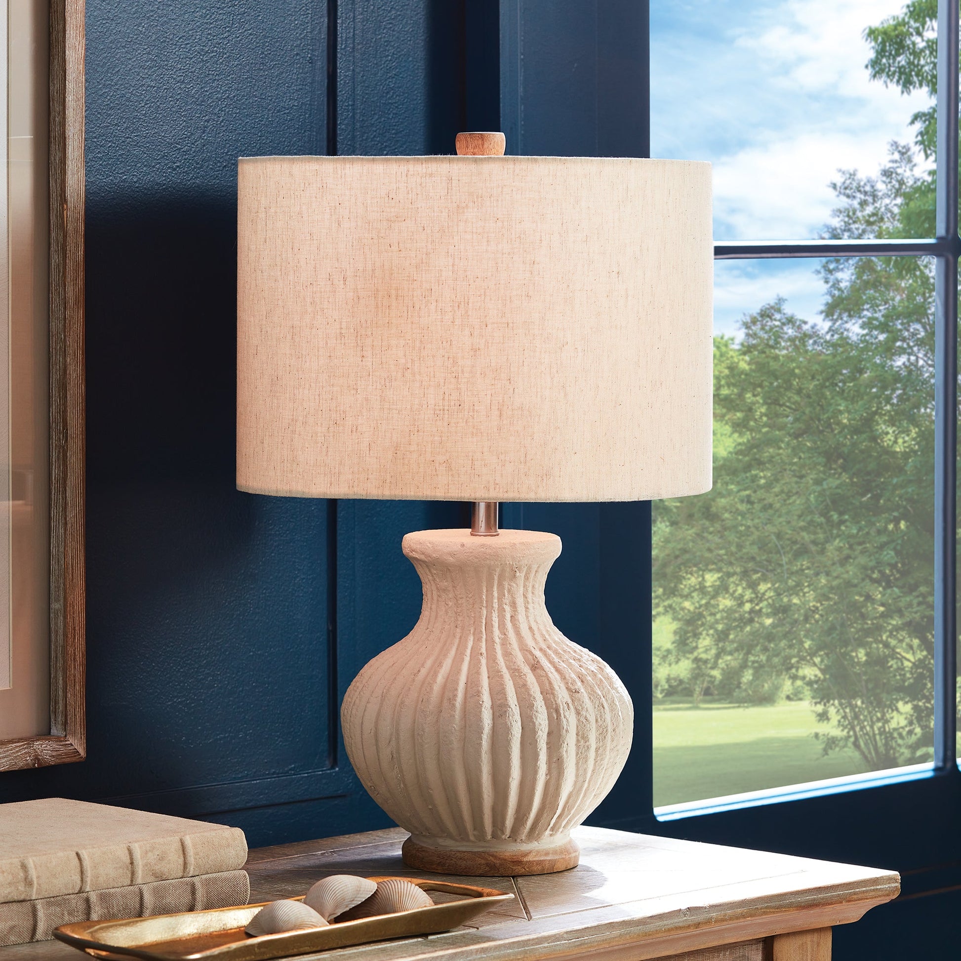 Crafted from a blend of natural, eco-friendly materials, the Margot Table Lamp features a warm white finish with a textured surface that showcases its unique composition. Complete with a linen shade and ribbed design, this contemporary compact table lamp is perfect for use on a bedside table or desk.