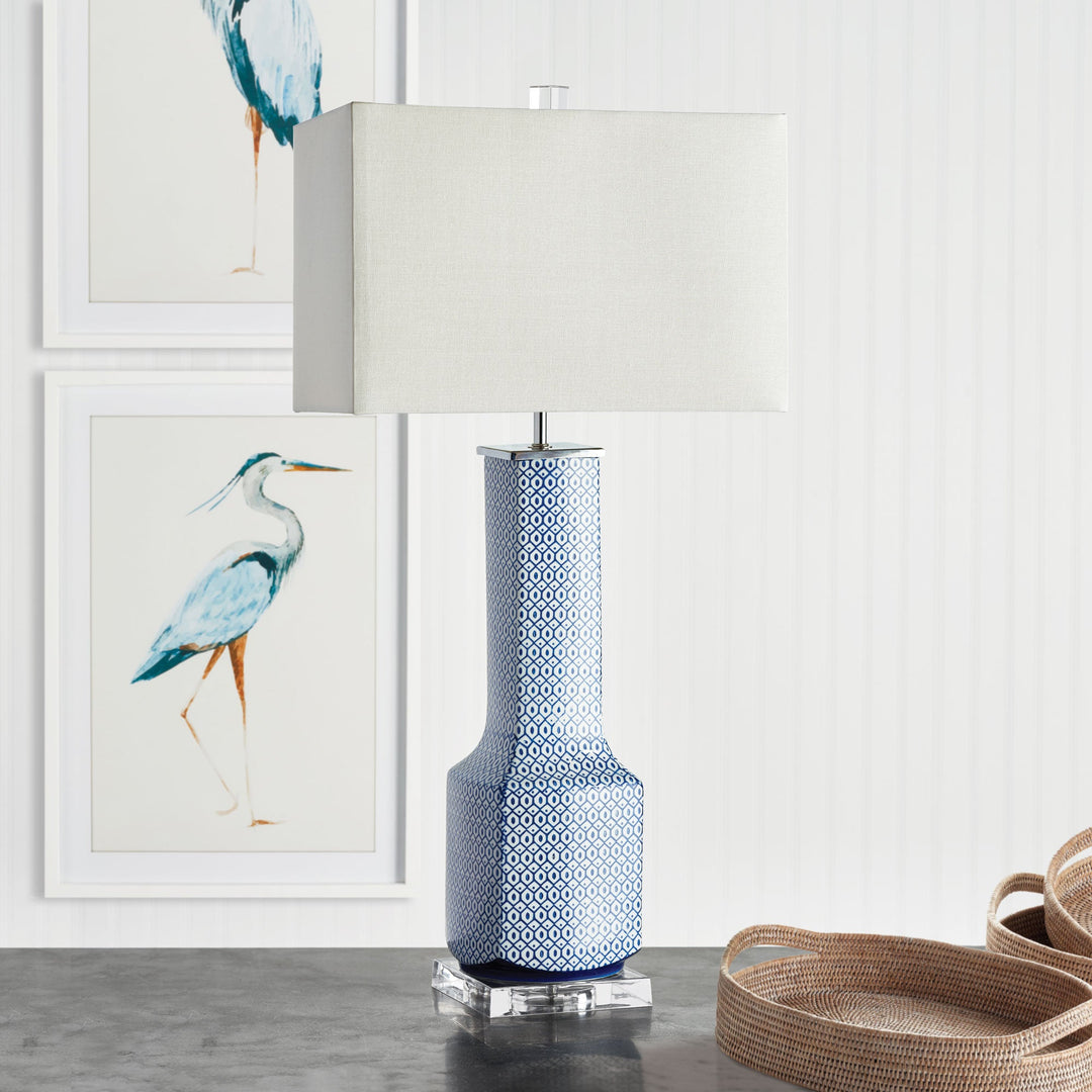 Enhance any transitional space with this beautiful table lamp that features a unique design and elegant texture. The ceramic base adds sophistication while the linen shade provides a soft, warm glow. This stunning piece is the perfect addition to elevate the style of any room, with its timeless Asian theme.