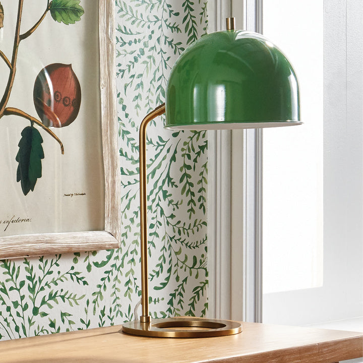 Constructed with a striking combination of a luxurious emerald green metal lamp shade and a sleek, contemporary base, this desk lamp is sure to make a statement in any home or office