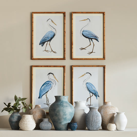 Experience the splendor of nature with the Elegant Blue Heron Wall Prints, Set Of 4. Enclosed in sleek, fir wood frames, these prints offer a sophisticated and charming touch to your beach cottage or villa. Embrace the captivating beauty of nature's finest creatures and elevate the atmosphere of your home with this stunning set.