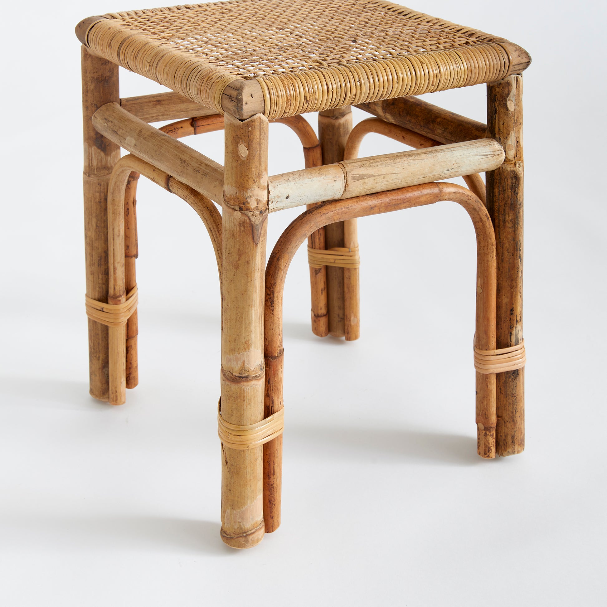 Featuring a robust wooden structure and intricate caning, the Anton Rattan Side Table is a stylish and versatile addition to any room. Use it as a chic accent piece next to your sofa or in any desired location. The table is expertly crafted from solid wood and boasts beautifully woven caning details for an elegant and sophisticated touch.