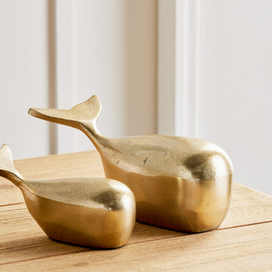 Add a touch of elegance to your coastal-inspired space with this sleek and modern set of Gold Whale Sculptures. Made from durable aluminum, these sculptures are a beautiful and charming accent for any shelf or surface. Whether for an art enthusiast or home decorator, these solid sculptures are sure to impress with their stunning design and construction.