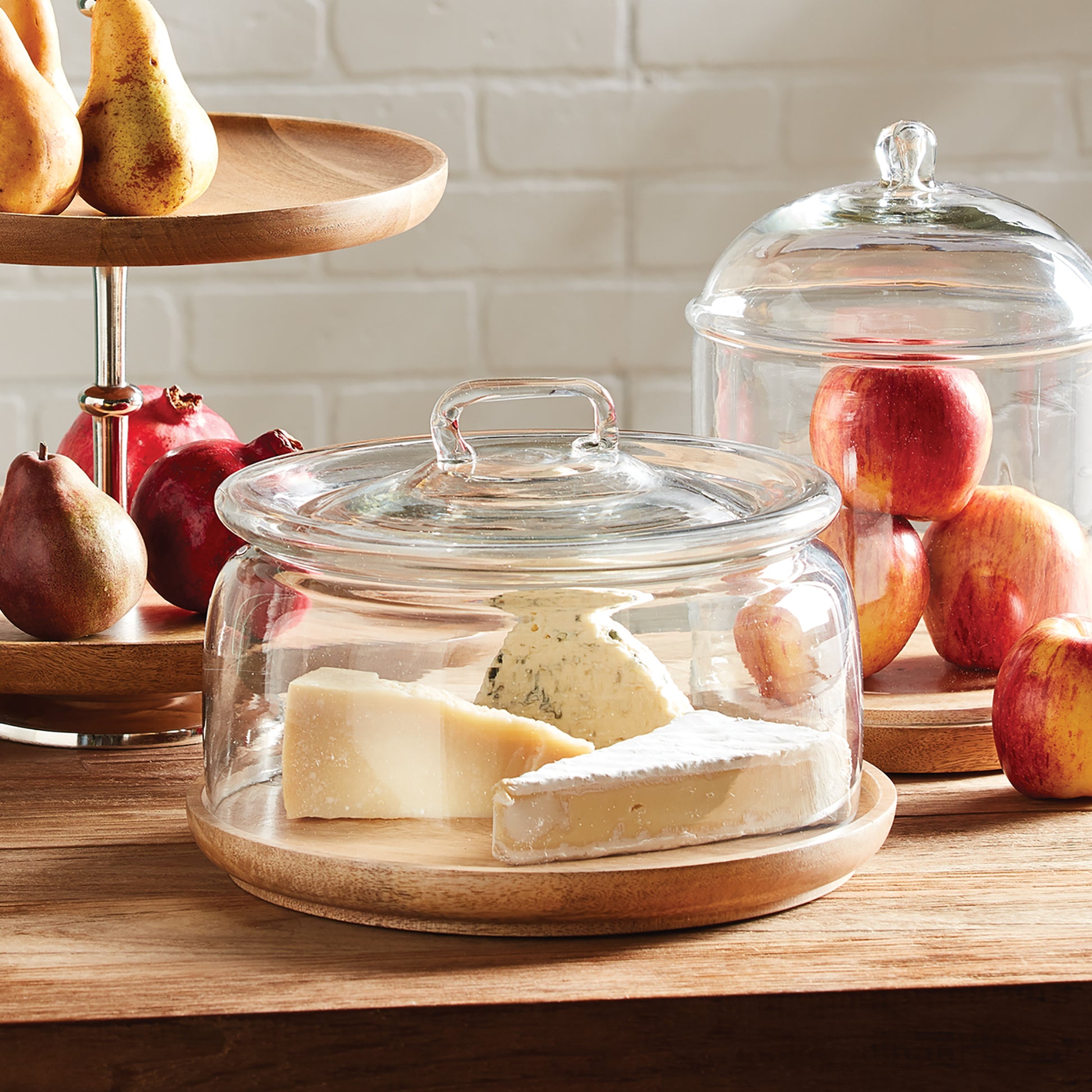 The Adrien Serving Tray With Cloche features a timeless design and a convenient handle, making it ideal for serving cheese, pastries, or rolls. Additionally, the natural wood board adds a warm touch to your serving table, making it perfect for any occasion. This cloche is a practical and visually appealing solution for storing and displaying your favorite items.