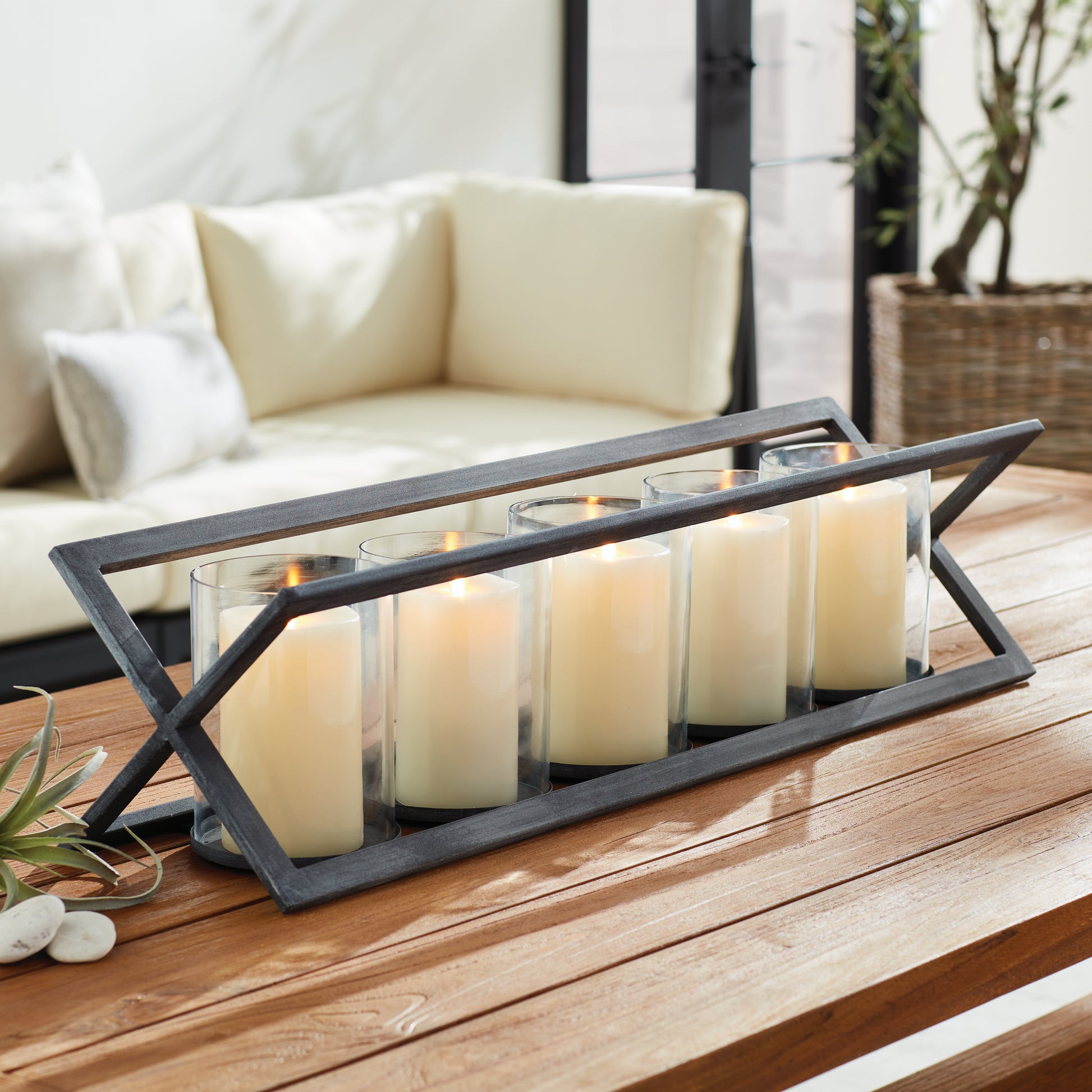 Professionally designed and expertly crafted, the Baxton 5-Pillar Candleholder boasts a stunning zinc finish and drainage holes for added durability. Its timeless design and functional features ensure long-lasting beauty and functionality.