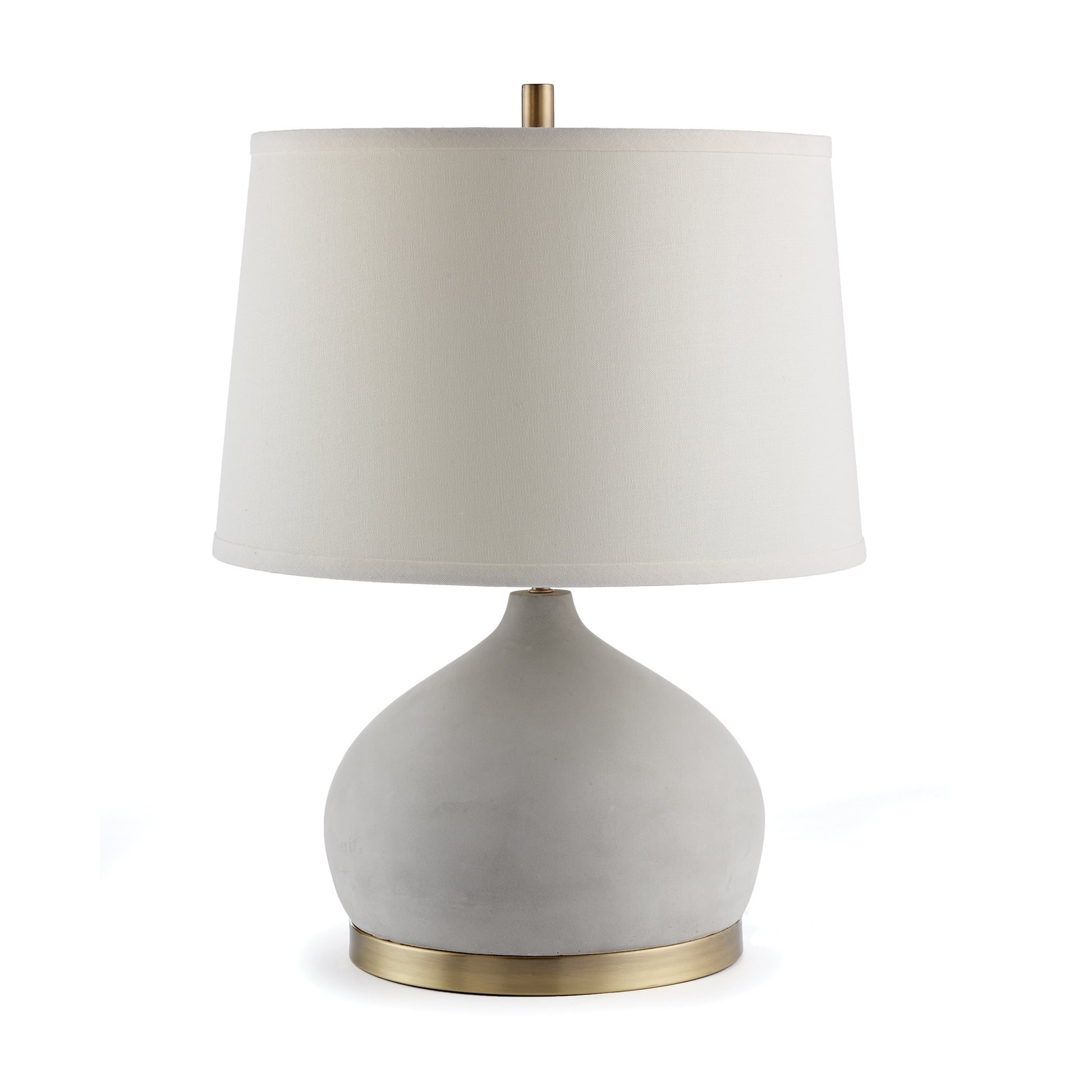 An unexpected mix of cement and brass accents make the Suki lamp a stand out fixture. Extra curvy Base and wide shade are details that add style and personality.