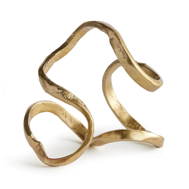 Gold sculpture with wavy design on a white background
