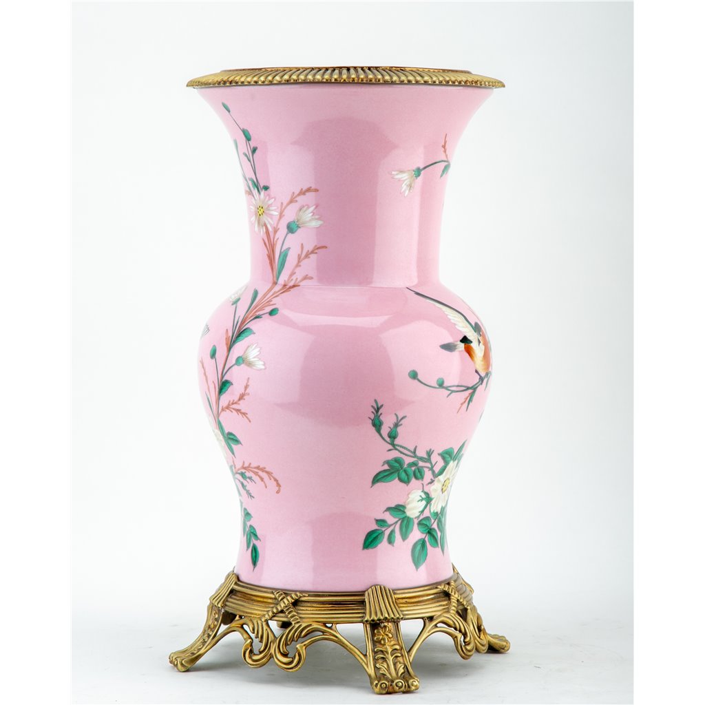 Introducing the Khom Pink Floral Pattern Vase, adorned with delicate flowers and birds. Made of high-quality porcelain with bronze accents, this decorative vase adds elegance to any living room or garden collection. Expertly crafted for a timeless and beautiful addition to your home.