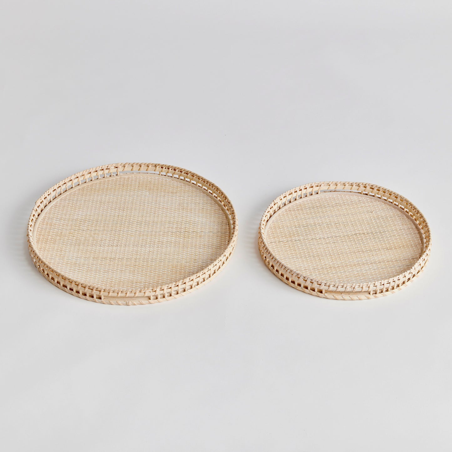 Crafted from woven rattan and coated with a fresh whitewash finish, these coastal-inspired trays add a touch of charm to any space. Use them on your coffee table or ottoman as a stylish base for creating beautiful vignettes. Enhance your home decor with Barri Coastal Decorative Trays Set of 2.