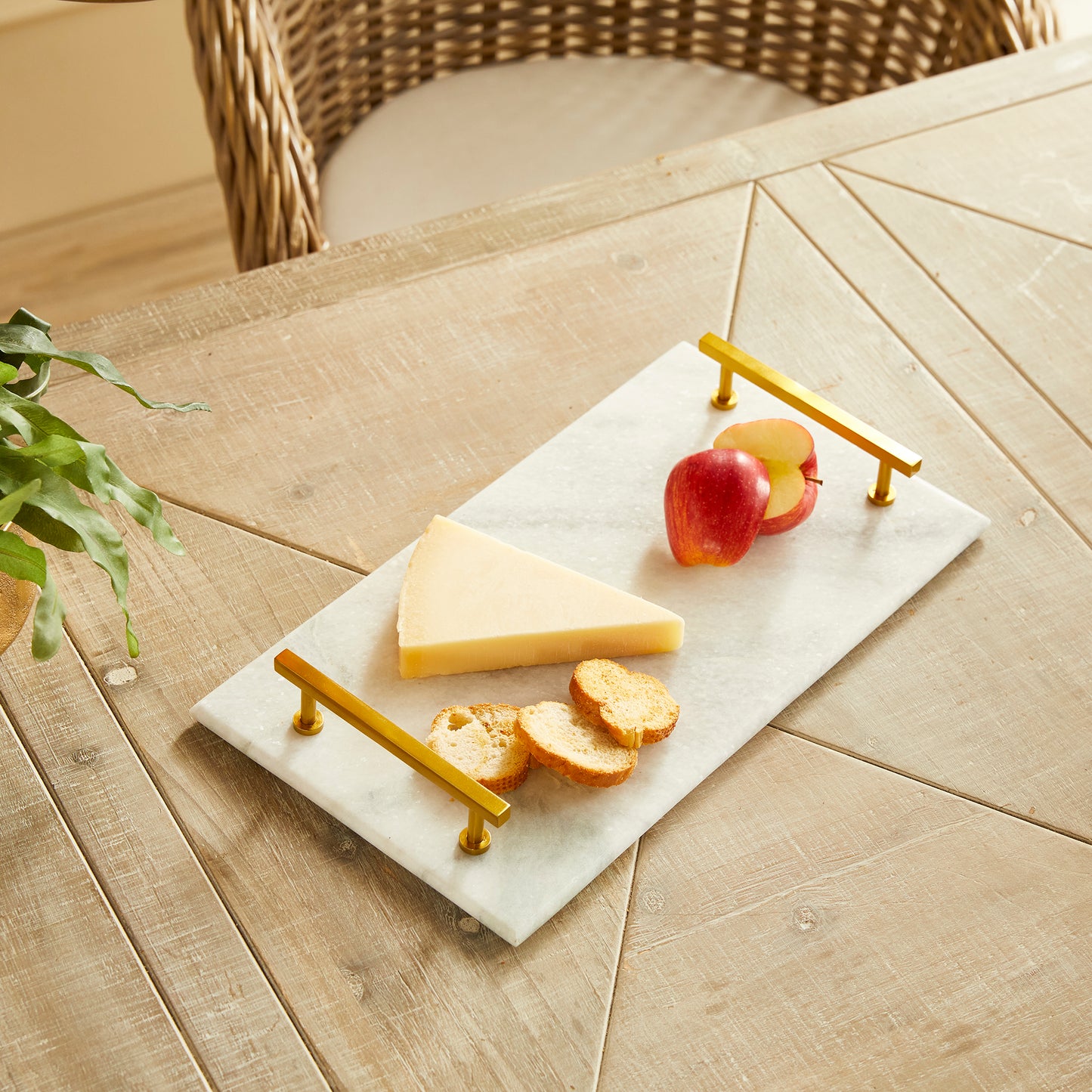 This Marble Serving Tray features a timeless pairing of marble and brass, making it the perfect way to present your favorite cheese and cracker platters. Its versatile design is suitable for coastal, traditional, and transitional settings, elevating your hosting game with a touch of sophistication. Whether you're serving a decadent cheese platter or a simple cracker spread, this tray is sure to impress, adding an elegant touch to any occasion.