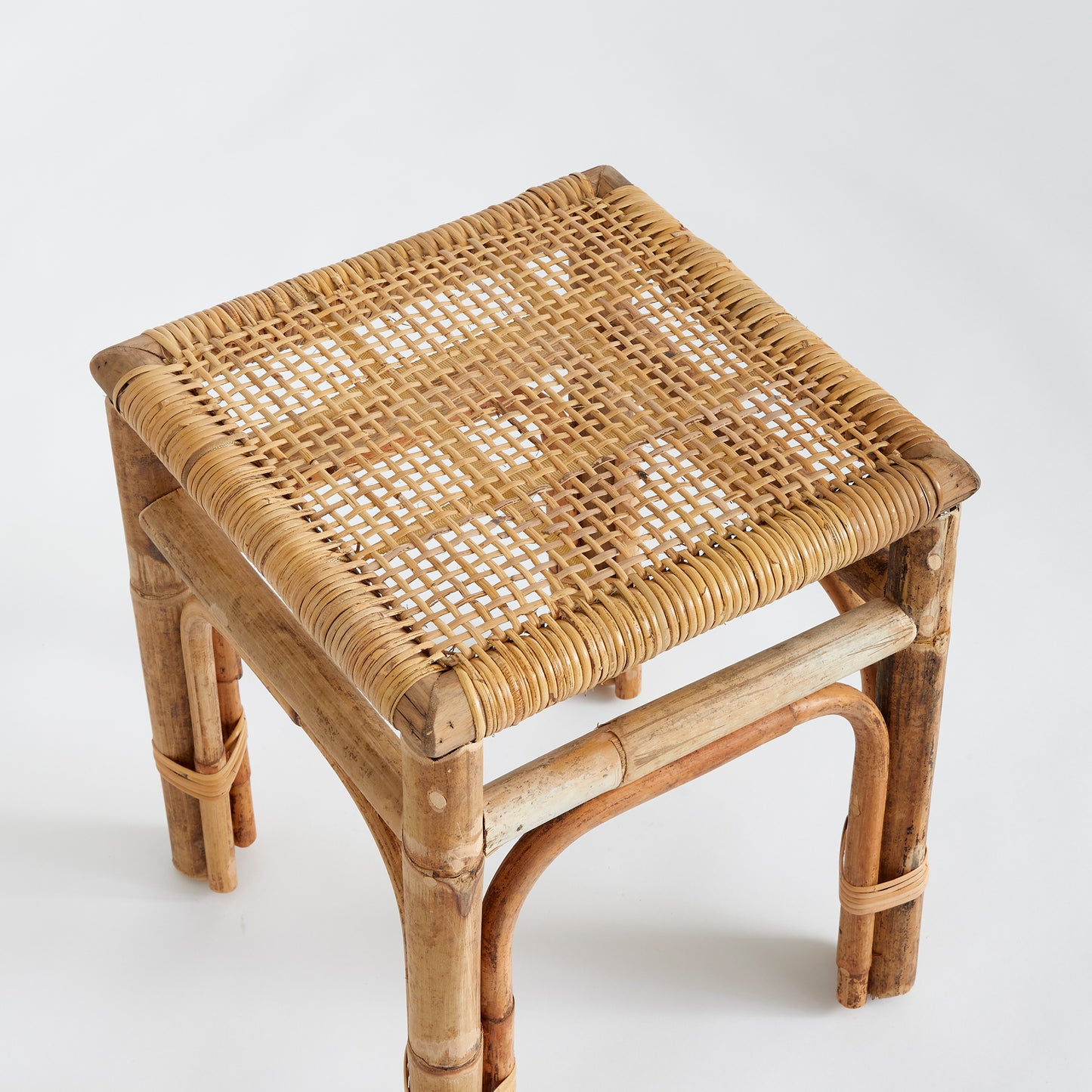 Featuring a robust wooden structure and intricate caning, the Anton Rattan Side Table is a stylish and versatile addition to any room. Use it as a chic accent piece next to your sofa or in any desired location. The table is expertly crafted from solid wood and boasts beautifully woven caning details for an elegant and sophisticated touch.