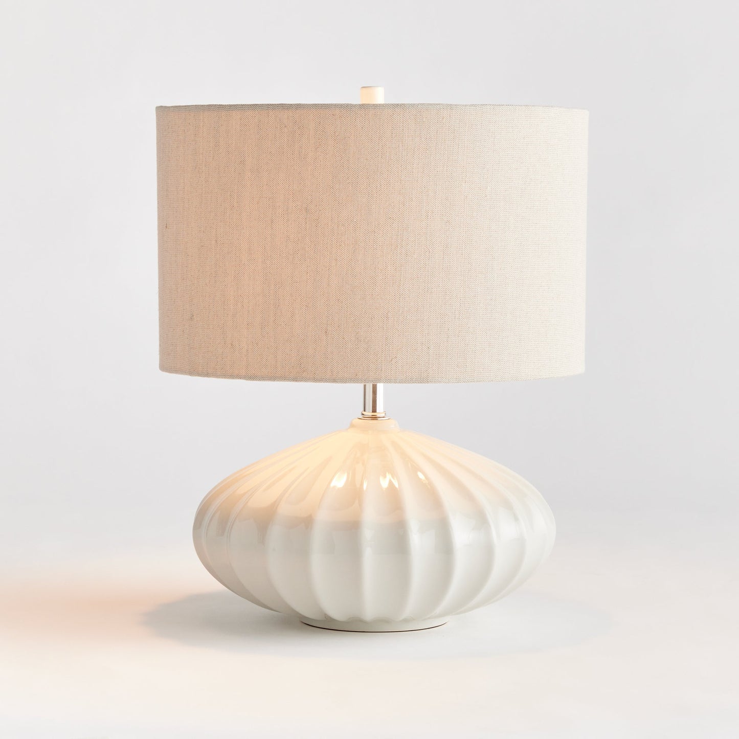 Crafted with intricate detail, the Lillet White Table Lamp boasts a curved ceramic base that sets it apart. Its grand scale and sweeping design make it a striking focal point in any transitional space. Unique, versatile, and elegant, this table lamp is a must-have for any lighting enthusiast.