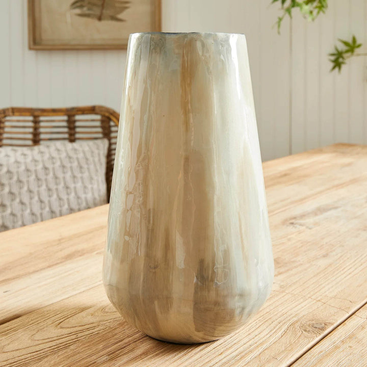 Using enameled iron in an innovative manner, these delicately crafted vases are hand-painted, each one featuring a charming tone-on-tone design. This technique produces a lovely light and creamy effect, making for a distinctive addition to any space. Crafted with expertise, Almeta White Pearl Vase Small stands out with its innovatively crafted enameled iron and charming tone-on-tone design. This unique technique produces an elegant, light and creamy effect that adds a distinctive touch to any room.