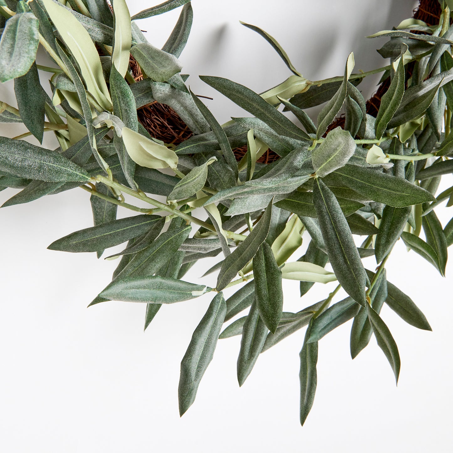 This olive wreath is a charming addition to any space needing a touch of warmth. Distinctive and refined, it's no wonder this Mediterranean beauty has stood the test of time. Comes complete with a twine loop for easy hanging. Use as a candle centerpiece on a table or hang on an interior door.