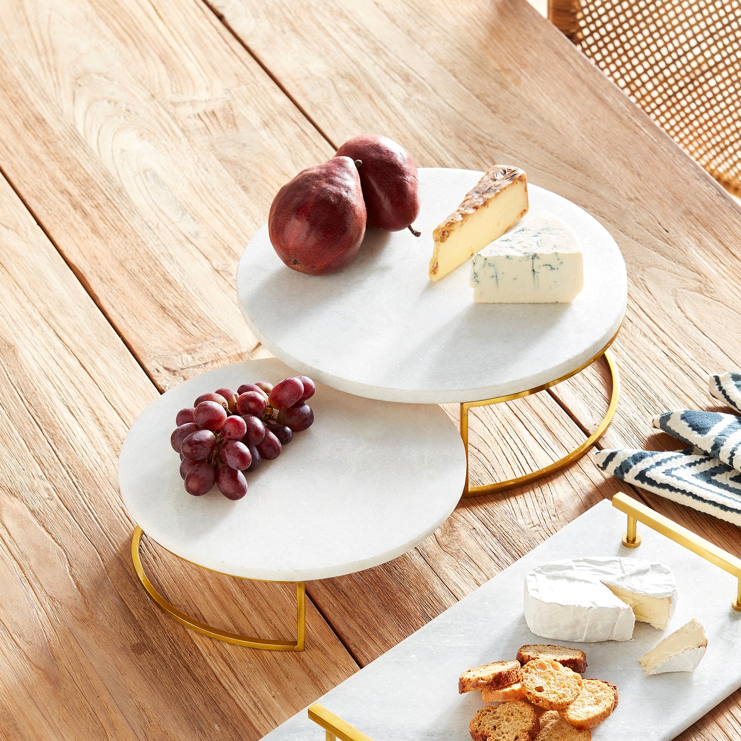 Enhance your serving experience with these sophisticated serving stands made from marble and brass, perfect for any occasion from coastal gatherings to traditional or transitional settings. The combination of marble and brass adds a touch of elegance to your favorite cheese and cracker spreads. Versatile yet timeless, these stands are a must-have for your serving collection.