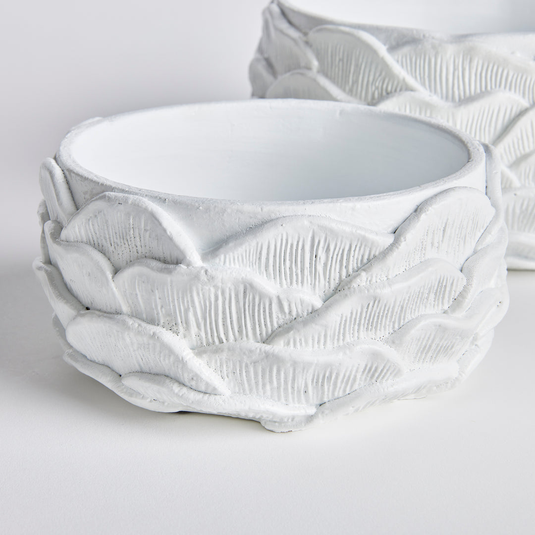 The Ashika Concrete Planter Pots, Set of 2, features an expertly crafted, layered design that adds an artisan touch to any space. With a bright white glaze and meticulous hand finishing, these pots offer exceptional value and a professional appearance. Whether displaying lush greens or a beautiful orchid, these pots are sure to add a nature-inspired element to your home.