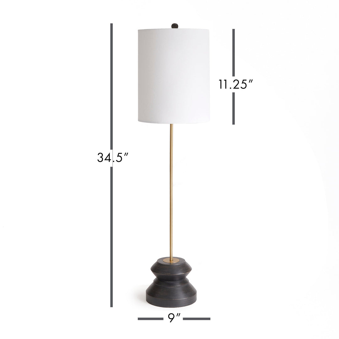 This tall, narrow lamp features a geometric turned wood black wash base, making it ideal for placement on either side of a long console or entry table. With its sleek and straightforward design, it provides a lovely way to illuminate a room with its soft light and black and gold accents, complemented by a linen shade.