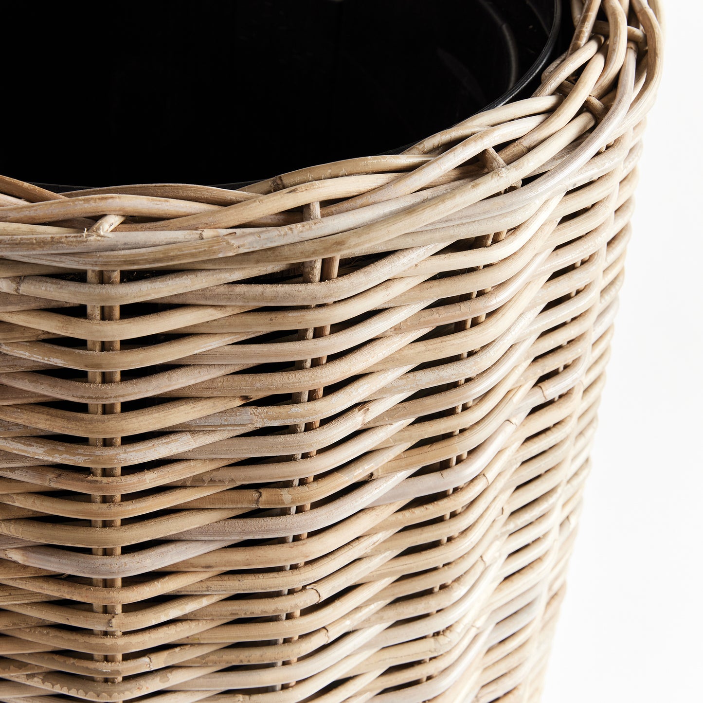 Discover the stunning beauty and unparalleled durability of this natural rattan planter. Its expertly crafted design features a distinctive flattened weave and sturdy iron frame, making it a must-have for both rattan enthusiasts and avid plant lovers alike. And with the included grower's pot, your plants will have the perfect foundation for optimal growth. Invest in the best with this tall rattan planter.