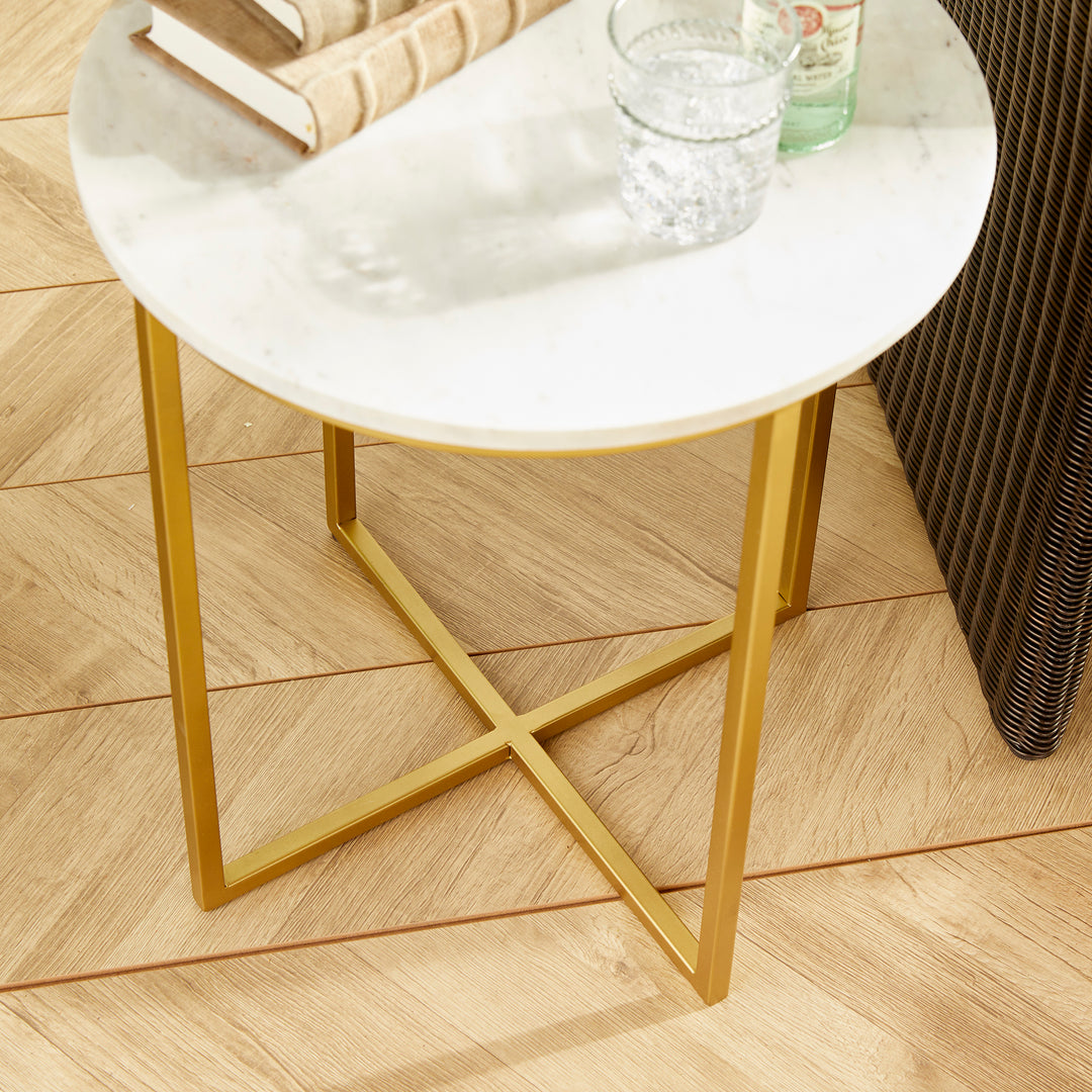 Crafted from a blend of white marble and brass, this elegant cocktail table exudes a timeless and sophisticated aesthetic. Its smaller size makes it a versatile piece that can easily be moved around, whether it's for serving cocktails, appetizers, or providing a sturdy surface for a laptop.