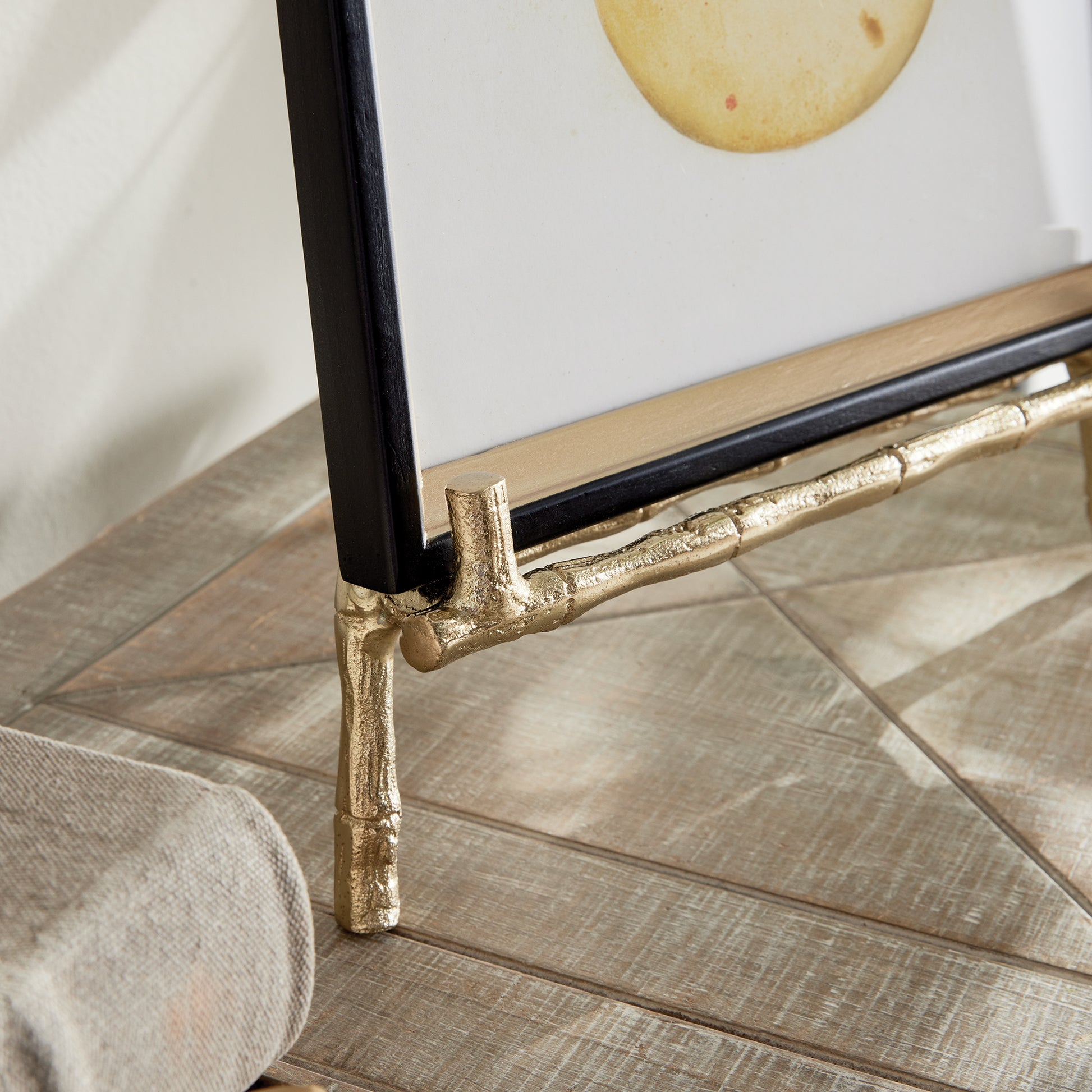 Crafted with precision and durability in mind, this dependable easel is perfect for showcasing platters, cookbooks, and small art pieces. Its sturdy and durable construction is complemented by elegant gold bamboo details, adding a timeless touch to any room's decor. Versatile and sophisticated, this easel makes displaying your favorite items a breeze while elevating the aesthetic of any space.