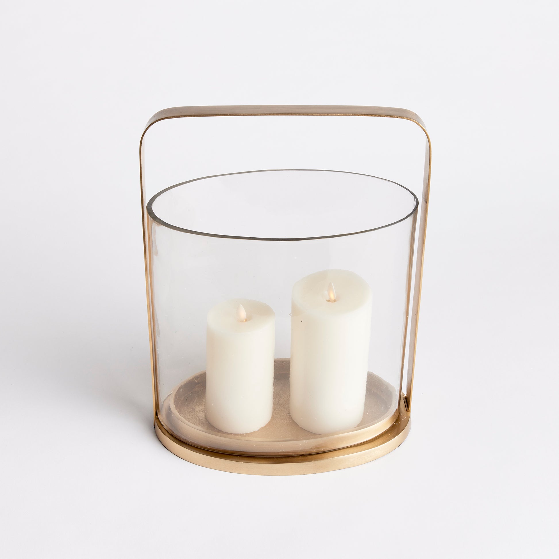 Crafted with a rare oval shaped glass hurricane, this candleholder is truly a masterpiece. Its simplistic design and warm matte brass details enhance its appeal. Expertly crafted and uniquely designed, the Aila Oval Hurricane Candle Holder is a stunning addition to any home decor, providing an elegant oval shape and a touch of sophistication with its warm matte brass details. This candleholder is the perfect blend of art and functionality.