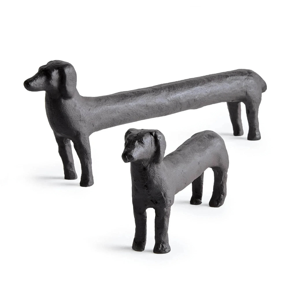 Two black aluminum dog figurines on a white background