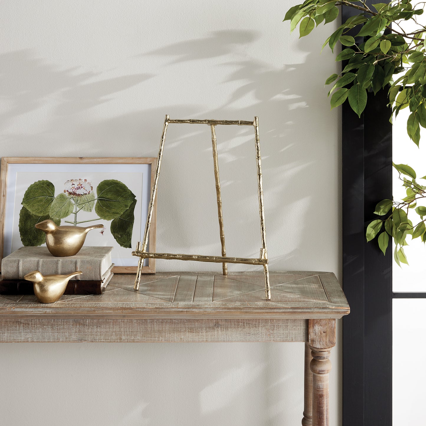 Expertly designed to securely hold heavy objects such as platters, cookbooks, and small pieces of art, the Gold Easel Large is the perfect choice for versatile display needs. Featuring a classic design with elegant gold bamboo-like details, this easel adds a touch of timeless sophistication to any setting. Its sturdy structure ensures the protection of your items while adding a professional and educational element to your display.