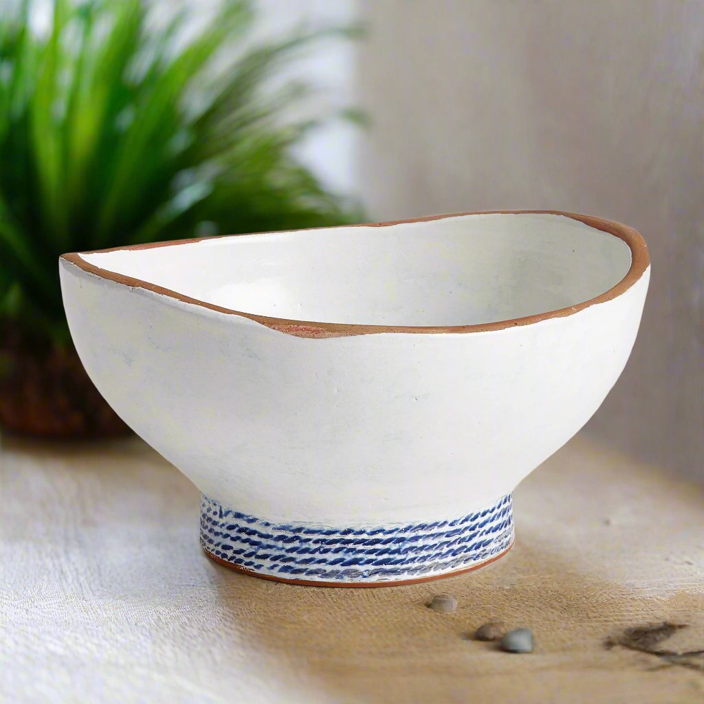 Our Coastal Themed Decorative Bowl features a Grecian blue striped design and exposed clay rim, evoking the beauty of the Mediterranean. The fully glazed interior adds a touch of luxury and elegance, making it a perfect addition to any coastal-themed decor. Whether used as a stunning centerpiece or to display fresh limes, this versatile bowl is sure to impress.