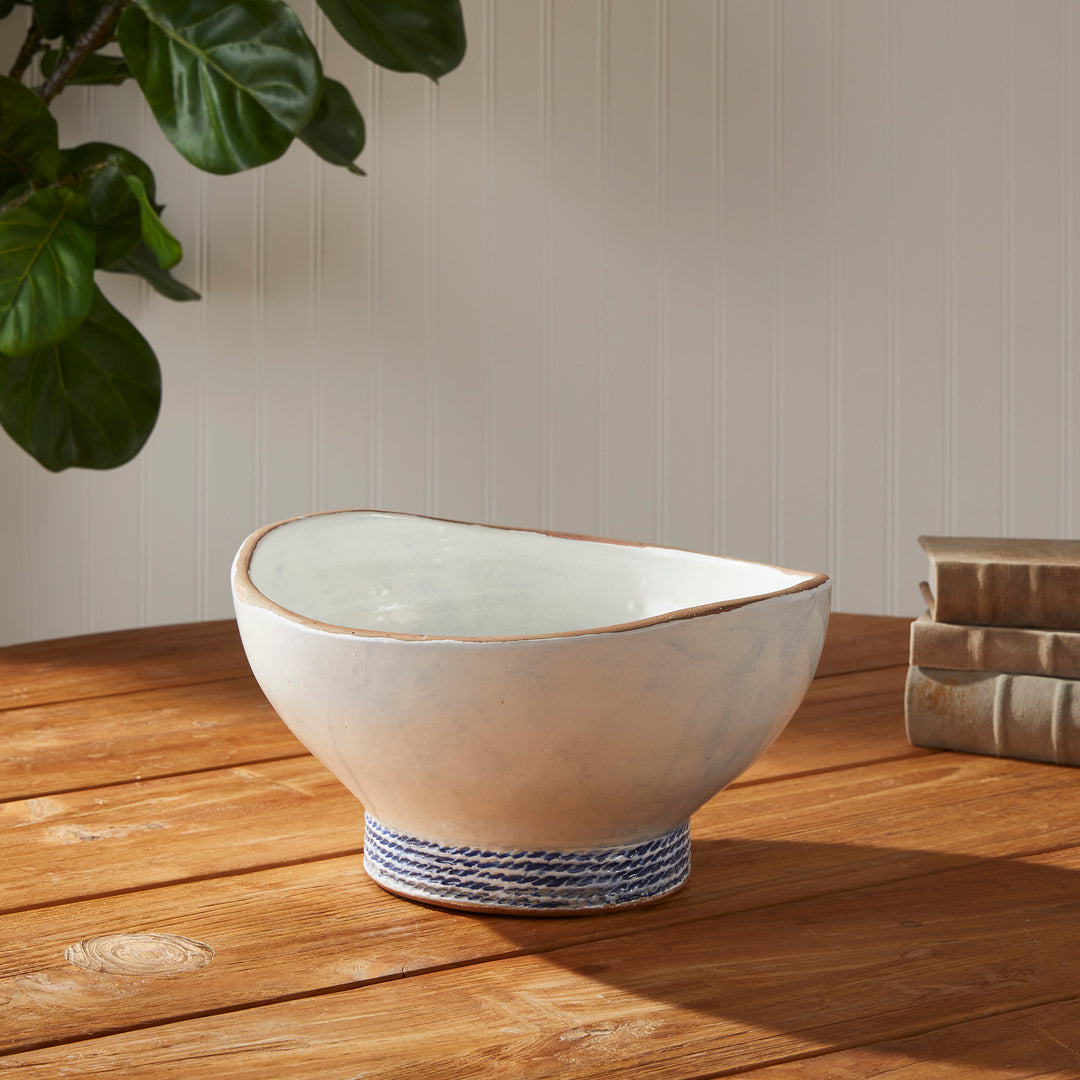 Our Coastal Themed Decorative Bowl features a Grecian blue striped design and exposed clay rim, evoking the beauty of the Mediterranean. The fully glazed interior adds a touch of luxury and elegance, making it a perfect addition to any coastal-themed decor. Whether used as a stunning centerpiece or to display fresh limes, this versatile bowl is sure to impress.