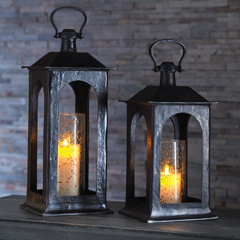 Enhance the ambiance of your space with this 25 inch Atherton Hurricane Lantern. Featuring a powder-coated finish and a seeded glass insert, this unique piece is perfect for any foyer or fireplace. Create a cozy atmosphere and warm up your space with its glowing light.