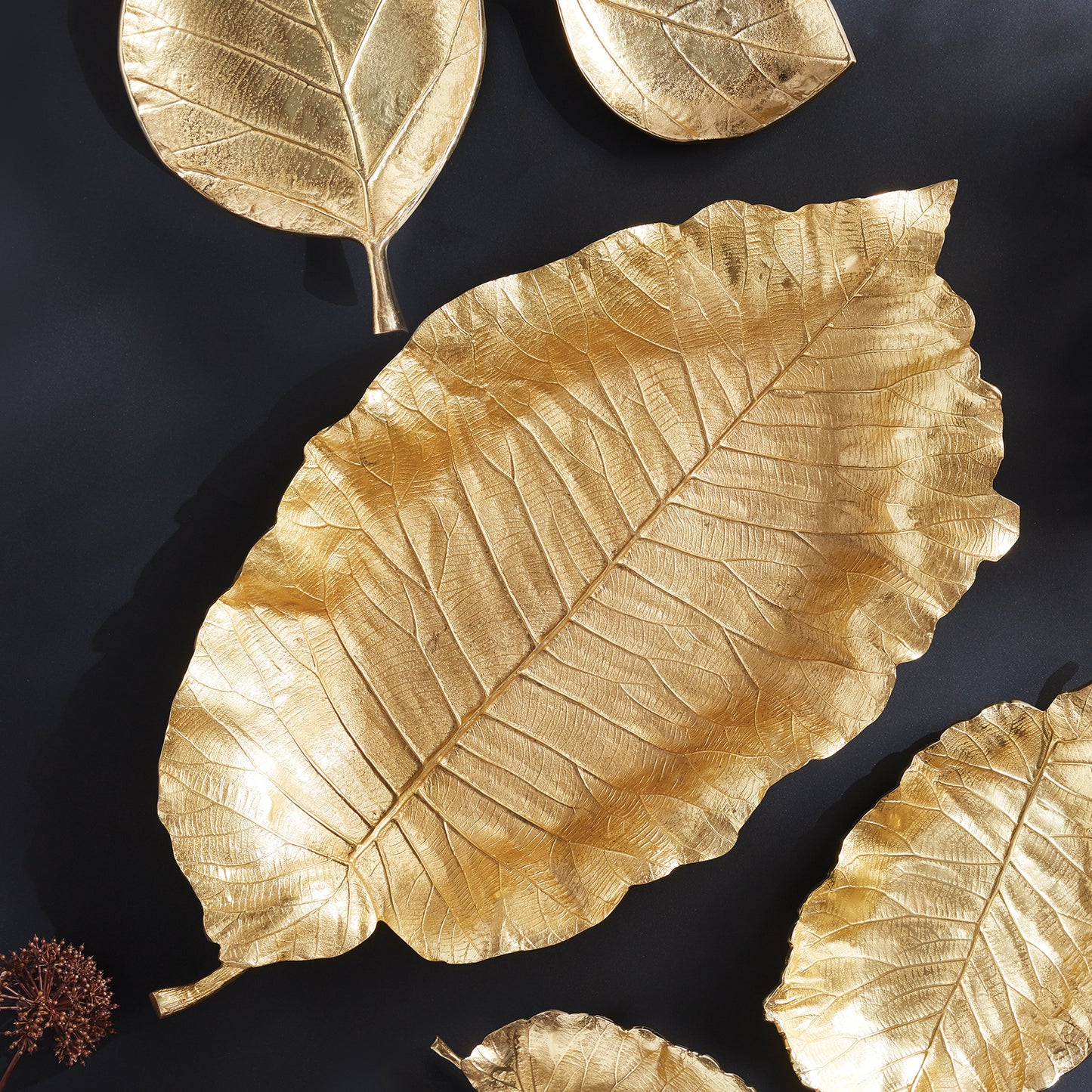 The Alegra Grand Leaf Tray boasts unmatched craftsmanship and unparalleled design. Each tray is carefully crafted using a hand-carved clay mold to capture the intricate details of natural leaves. Made with durable aluminum and finished in a rich golden hue, this tray adds a touch of sophistication to any coffee table, console, or countertop. Elevate your home decor with this grand tray that is sure to impress.