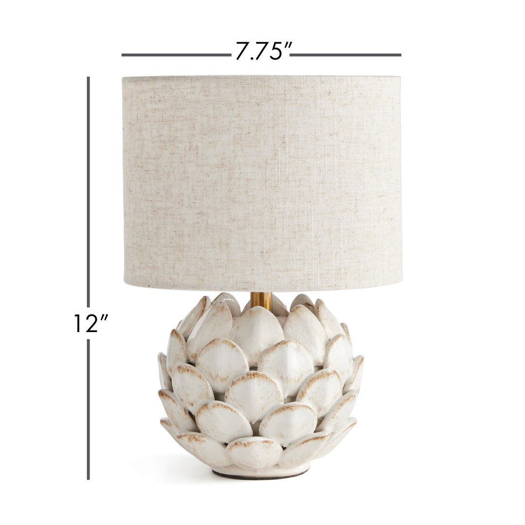 Transform your space with this exquisite ceramic table lamp, inspired by the intricate beauty of artichokes. Hand-finished with antique edges, it exudes a timeless elegance. Complete with a natural linen shade, this lamp is the perfect addition to any sophisticated and exclusive setting.