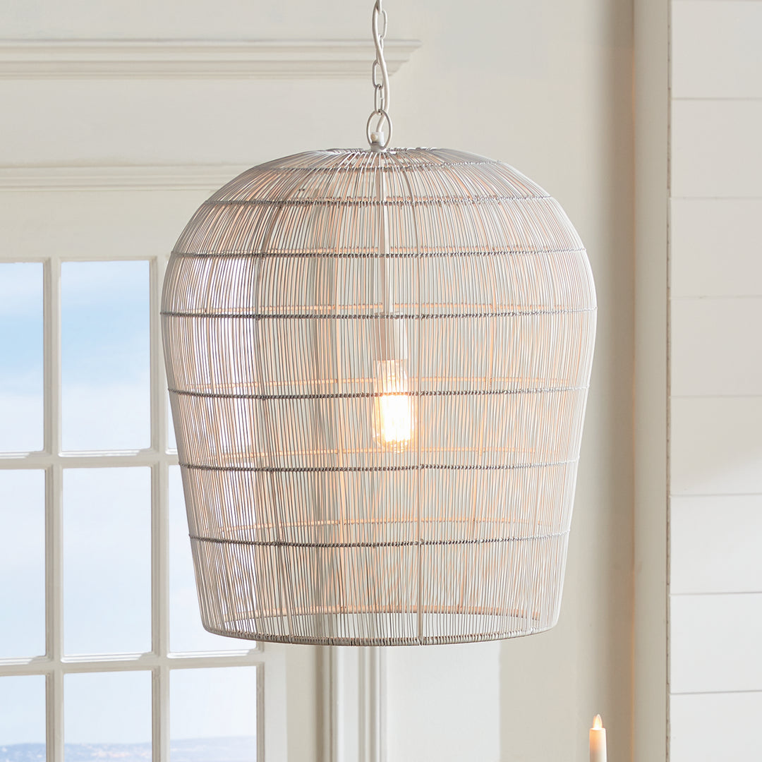 This pendant light features a solid iron frame that is elegantly wrapped in delicate white matte metal strands. With an open design, it brings a beautiful symphony of light, making it a great choice for placement in kitchens or foyer areas. Expertly crafted, it creates an elegant and grand aesthetic with its combination of materials.