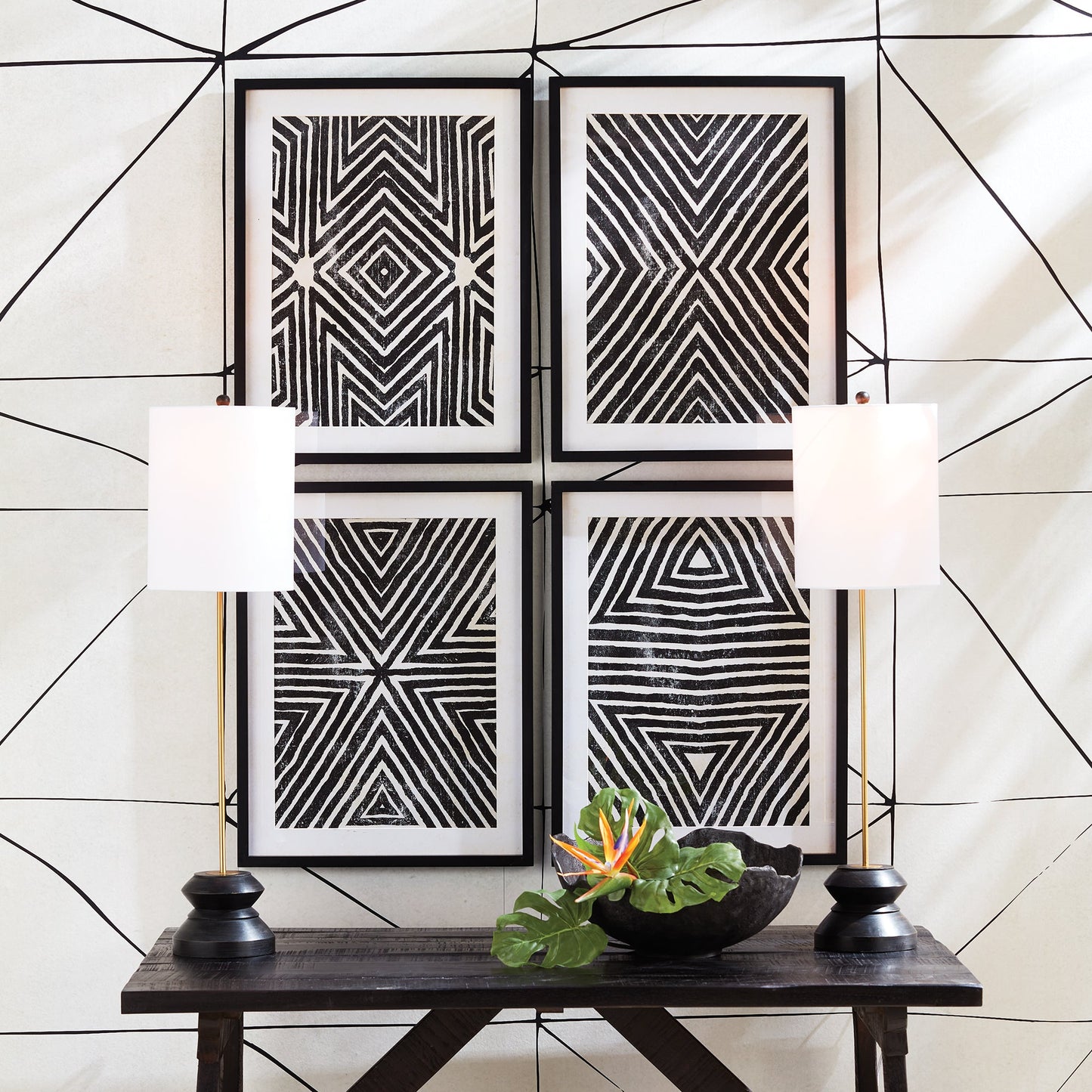 This tall, narrow lamp features a geometric turned wood black wash base, making it ideal for placement on either side of a long console or entry table. With its sleek and straightforward design, it provides a lovely way to illuminate a room with its soft light and black and gold accents, complemented by a linen shade.