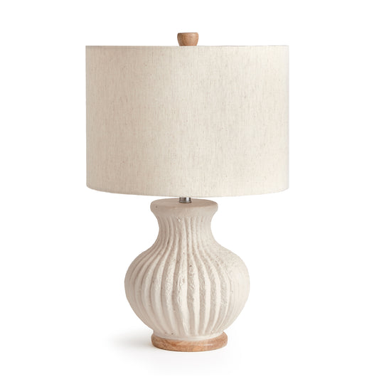 Made of a composite, natural Eco mix, this lamp Base is composed of hardening agents for longevity. The finish is warm white with a pitted texture that shows the composition of the material. With a linen drum shade and ribbed body, this petite lamp is great for bedside table or desk.