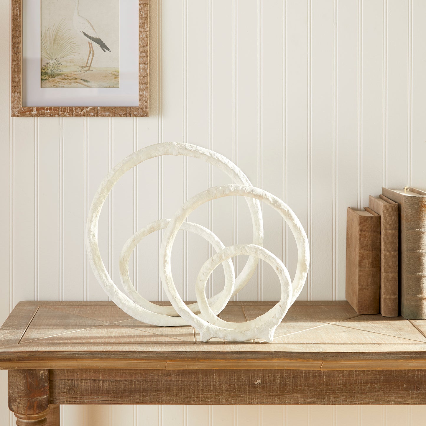 These two coordinating sculptures feature a modern matte white powder coat, adding sophistication to any space. Made of cast aluminum, they are both durable and aesthetically pleasing, with subtle coastal influences. Place them on a bookshelf, console, or mantel to instantly elevate your home decor.