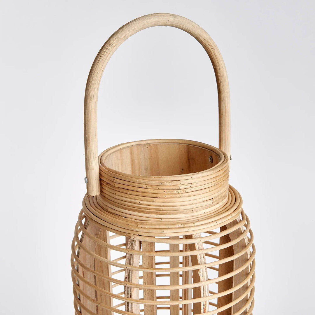 Crafted from sustainable bamboo, this tall and slim rattan lantern makes a statement while adding a touch of nature to any space. Its sleek design is perfect for coastal settings and beach houses, bringing the outdoors in with style and sustainability.
