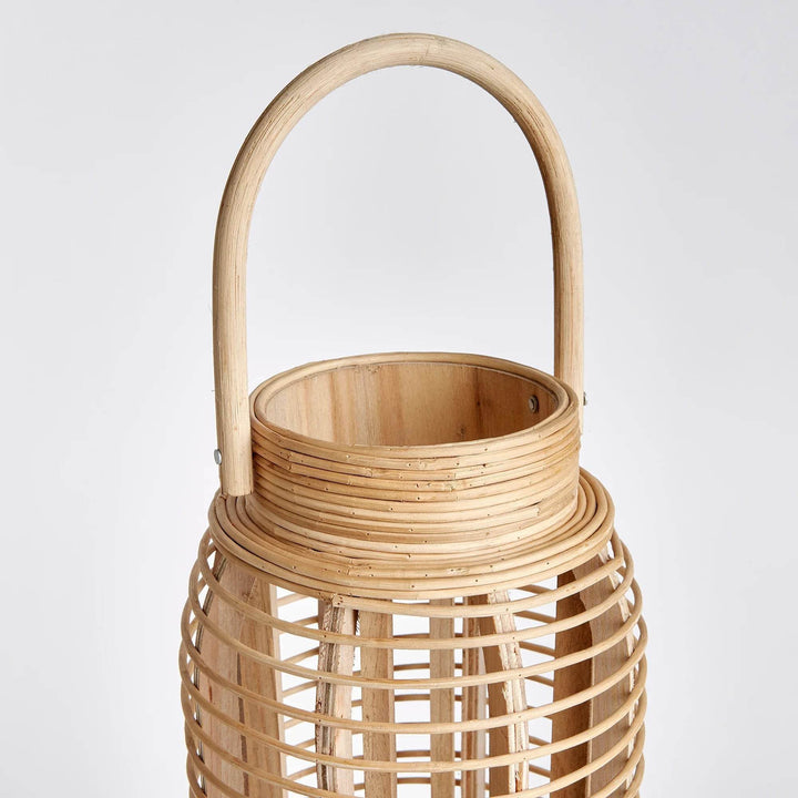 Crafted from sustainable bamboo, this tall and slim rattan lantern makes a statement while adding a touch of nature to any space. Its sleek design is perfect for coastal settings and beach houses, bringing the outdoors in with style and sustainability.