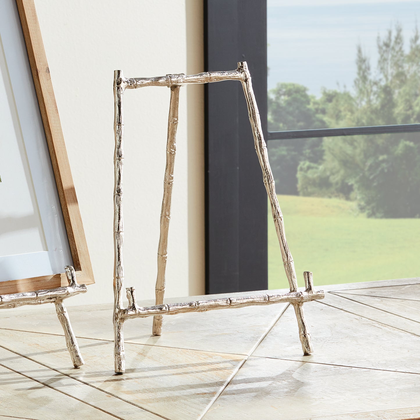 Expertly designed for a variety of uses, this silver easel provides a dependable and sturdy way to display platters, cookbooks, and small artworks. Its strong construction ensures the safety of your items, while the silver accents inspired by bamboo add a timeless touch to your presentation. A versatile and long-lasting choice for showcasing platters, cookbooks, or small artworks.