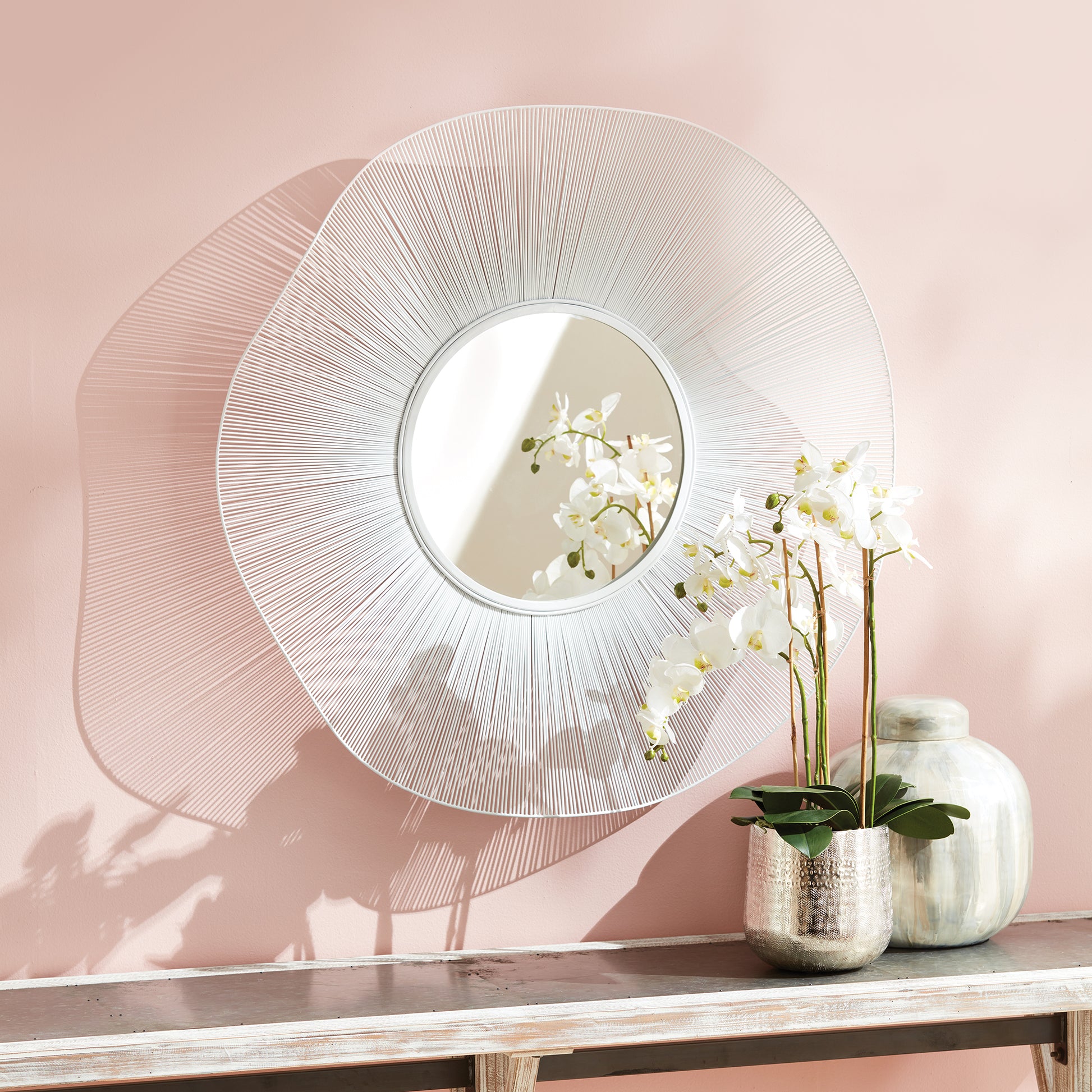 This Esme Coastal White Mirror is expertly crafted with an open design featuring intricate waves of white matte metal, creating a dramatic and eye-catching addition to any space. Use it as an anchor piece in your foyer or entryway, or as a stunning greeting for your guests. It is the perfect fit for a contemporary coastal retreat or to add a touch of brightness to any modern space. Trust in its quality and style to elevate your home decor.