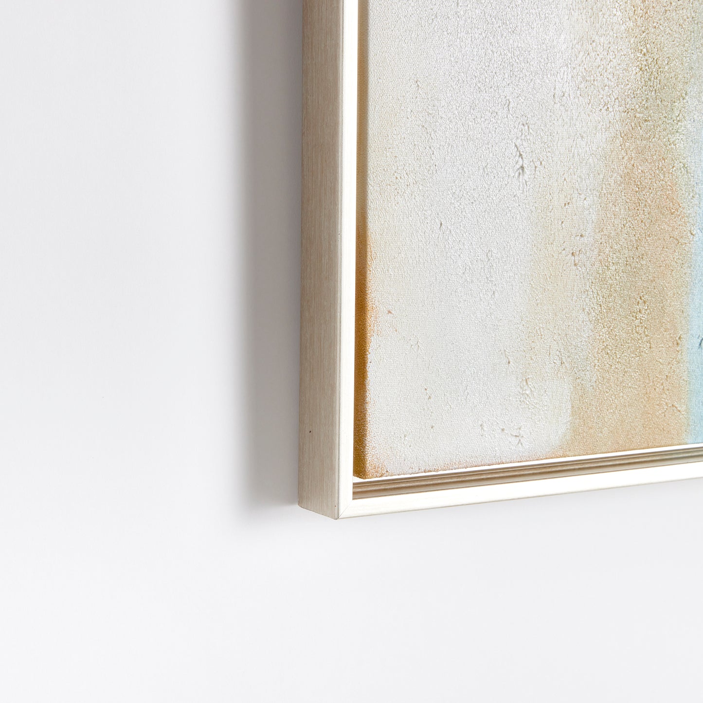 Experience the serene, coastal tones within this modern canvas. Drawing inspiration from Rothko's iconic style, this canvas is a study in color and balance. Each highlight is meticulously hand-embellished with touches of paint, creating a textured and dimensional piece. Complete with a sleek silver frame, this canvas is a stunning addition to any space.